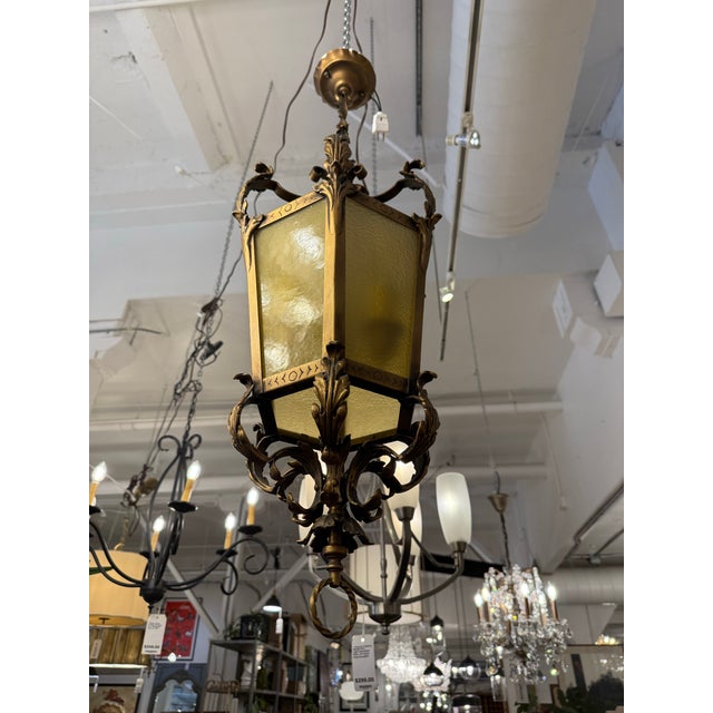 Design Plus Gallery presents a Gothic Revival Style Gilt Metal and Amber Glass Lantern Pendant. This hanging lantern has a...