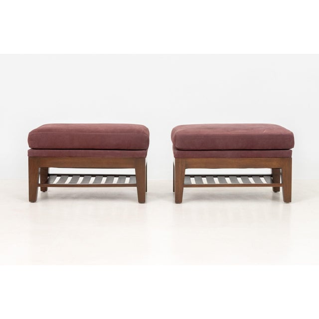 Pair of Burgundy Suede Upholstered Ottomans, each with four legs supported by an undertier. 13" H x 28" W x 17" D....