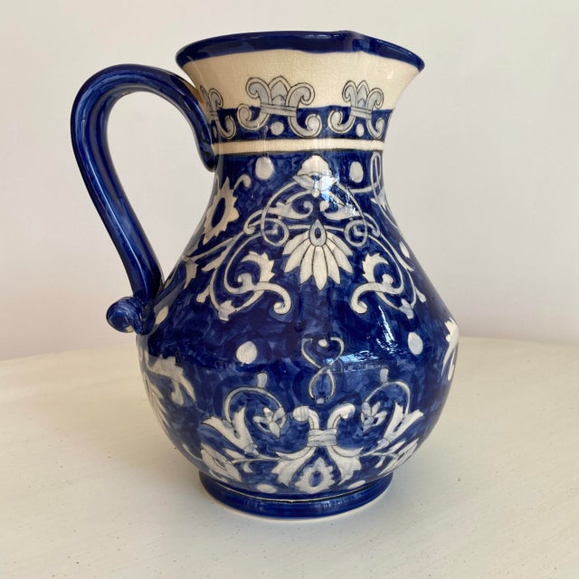 Beautiful vintage 1990s Italian hand painted blue ceramic pitcher with lemons and vines. In very good vintage condition...