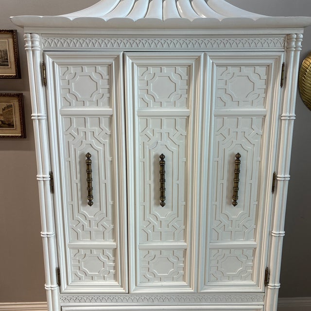 Awesome mid-century Thomasville chinoiserie style pagoda cabinet. Great cabinet for storing linens, clothing, or even to...