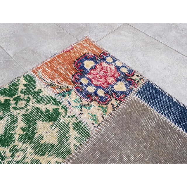 This is a vintage Turkish Oushak rug from the Mid 20th Century. The piece was hand-knotted.