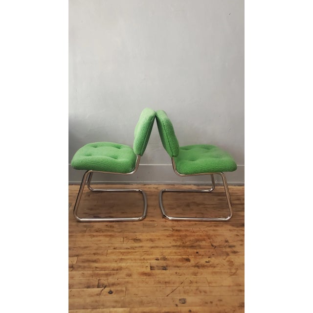 Vintage Steelcase Cantilevered Side Chairs. c. 1970s. Chromed tubular steel frame with seat and chair back upholstered...