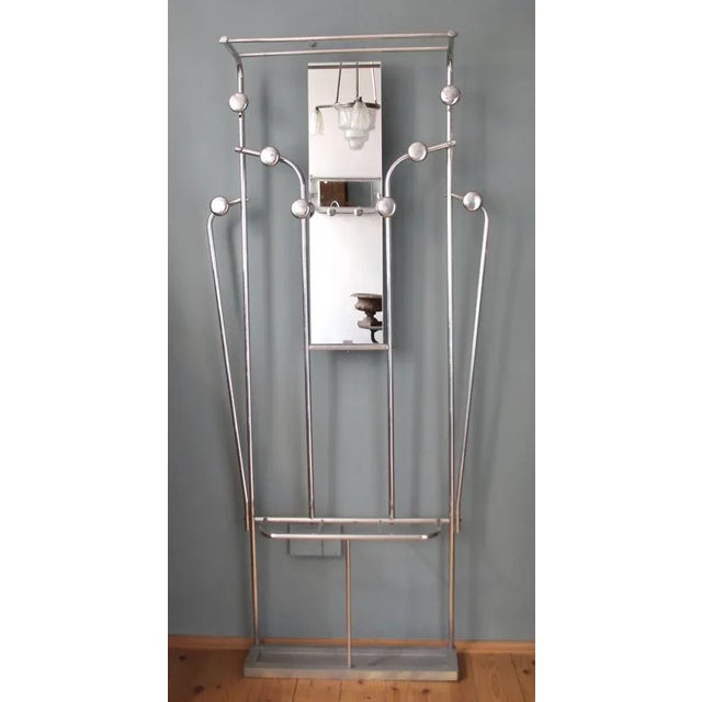 This coat stand was made and manufactured in France in the 1940s. It is made from polished aluminium with eight hooks. The...
