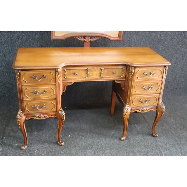 Louis XV style vanity with marquetry pattern and inlay design. Carved throughout with cabriole legs and dovetailed...