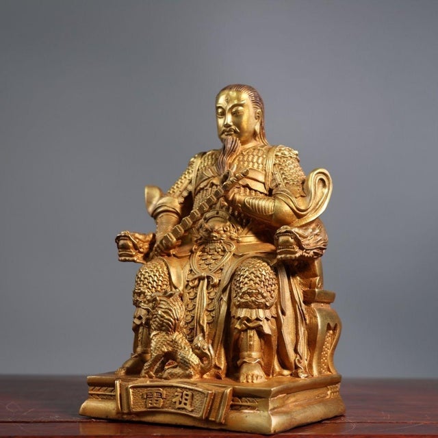 This is a finely crafted antique gilt bronze sculpture of the Zhenwu Emperor (also known as the Dark Warrior), a powerful...