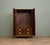 A superb quality compact wardrobe dating from the 1930s, featuring beautifully figured burr walnut doors with contrasting...