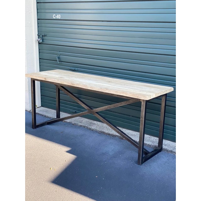Cool console from Timothy Oulton with heavy duty iron base. Reclaimed unfinished lighter colored wood with nice character....