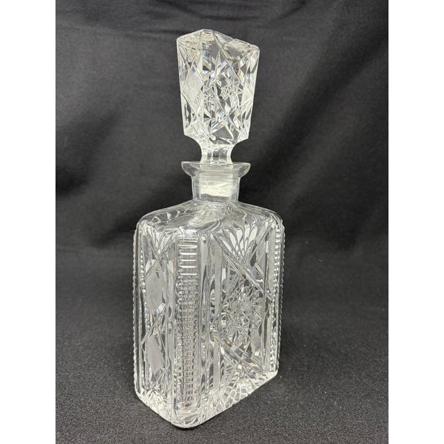 Vintage Cut Crystal Decanter with Cut Stopper Classic square-block design with starburst cut on either side of the...