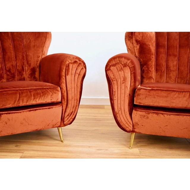 This rare pair of mid-century armchairs was produced by isa bergamo. The chairs have been restored and reupholstered in a...