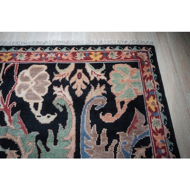 This black wool rug features a hand knotted pile weave that offers a substantial foundation for interior spaces. Crafted...