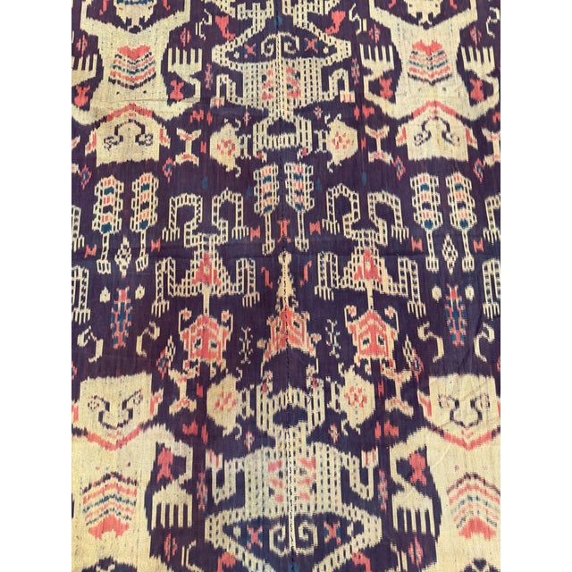 An extraordinary mid-19th century Indonesian inspired ikat tapestry featuring a highly unusual arrangement of stylized...