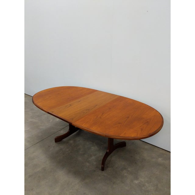 Authentic vintage mid century modern teak extendable dining table with built-in leaf. By G Plan. Maker's label on bottom...