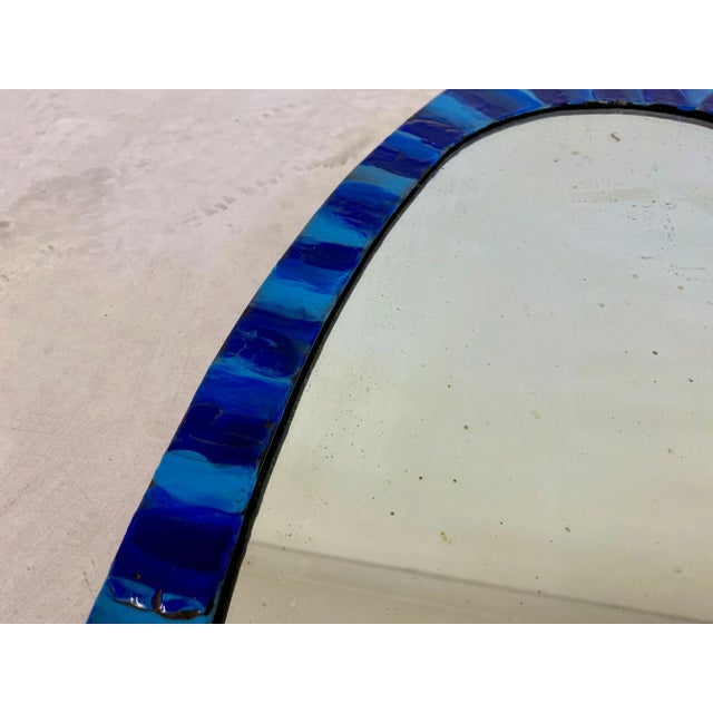 Oval shaped mirror By Siva Poggibonsi Enamelled copper Italy 1950s Foxing to the mirror This piece is attributed to the...