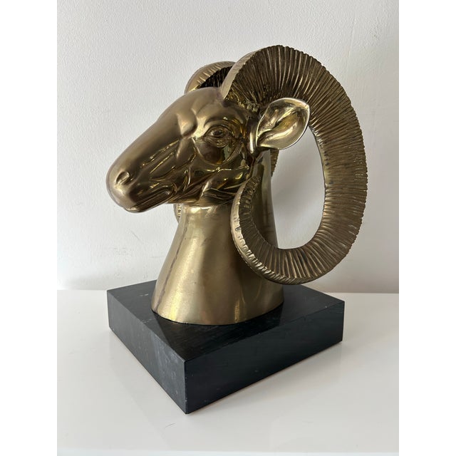 Mid century bronze rams head on black marble base. Striking addition to almost any decor-Hollywood regency, mid century or...