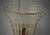 This transparent gold Murano glass wall light features a refined and delicate design. The wall light features a brass...