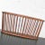 Handsome walnut oval magazine rack in the larger size attributed to Arthur Umanoff for Washington Woodcraft. It is in...