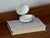 An oval hinged keepsake box in white glazed French porcelain, mounted in gilt brass with a scalloped shell thumbpiece. The...