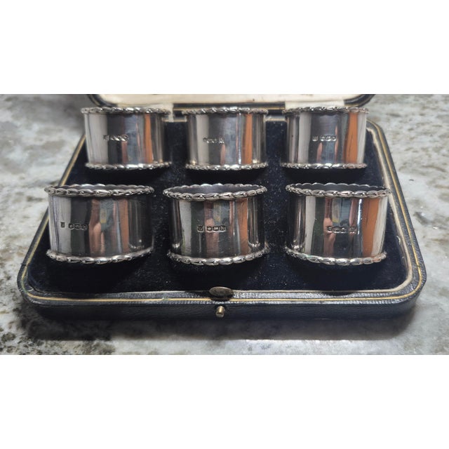 An exceptional, fine and impressive set of six antique George V sterling silver napkin rings - boxed; an addition to our...