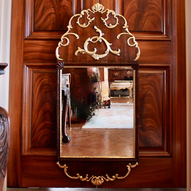 A striking crested Scandinavian Rococo mirror, likely Danish, with a cartouche form crest filled with gilded rocaille...