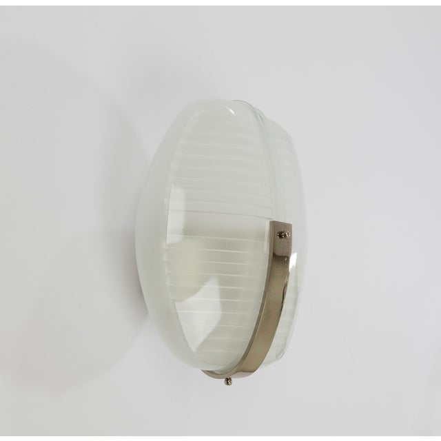 Lambda wall lamp in metal and glass, designed by Vico Magistretti and manufactured by Artemide in 1961. The wall lamp...