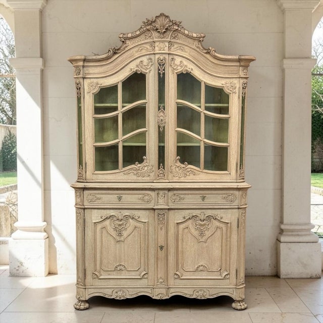 An antique Liegeoise Regence bookcase display cabinet of exceptional quality, hand stripped to reveal an antique patina of...