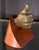This small cast bronze sculpture depicts a naturalistic hand giving a thumbs up, mounted through a angled triangular...