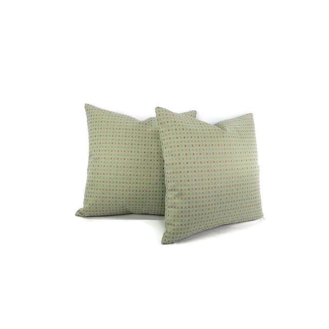 From Kravet Fabrics is Check Out in the color Poolside. This pillow feathers a check plaid pattern with colors of orange...