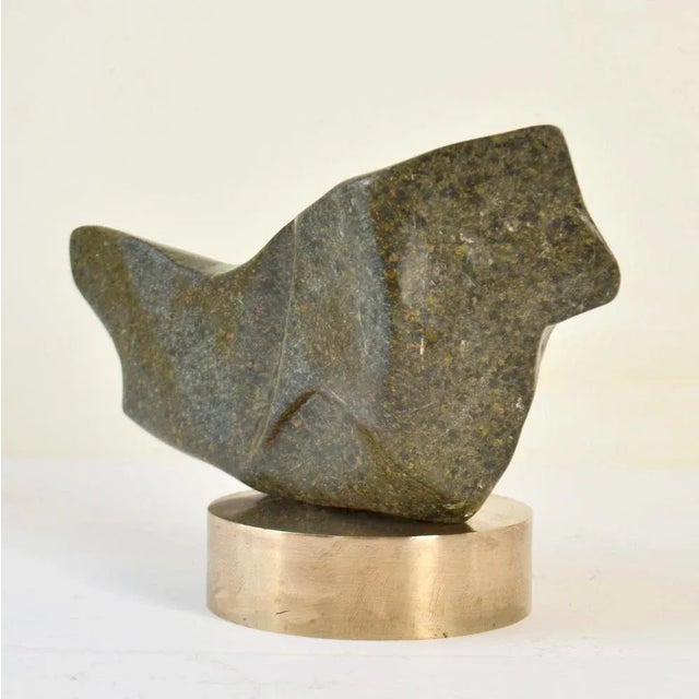 Hand-carved sculpture in moss green marble/ granite on a polished round bronze plinth by the late Alice Ward. Her...