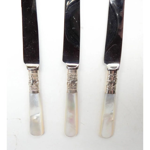 Set of 3 vintage fruit or dessert knives. Mother of pearl handles , unmarked emossed decorative silver ferrules. Marked...