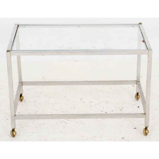 Postmodern Glass and Chrome Bar Cart, with brass accents to corners, on four casters. 18.5" H x 27.5" W x 16.5" D....