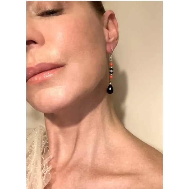 This is part of Chairish’s Fine Jewelry assortment. A very beautiful pair of Italian diamond, coral, black onyx, 18-karat...