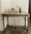 French veined marble topped table which includes floral open work frieze on all sides and carved fluted legs. Made in the...
