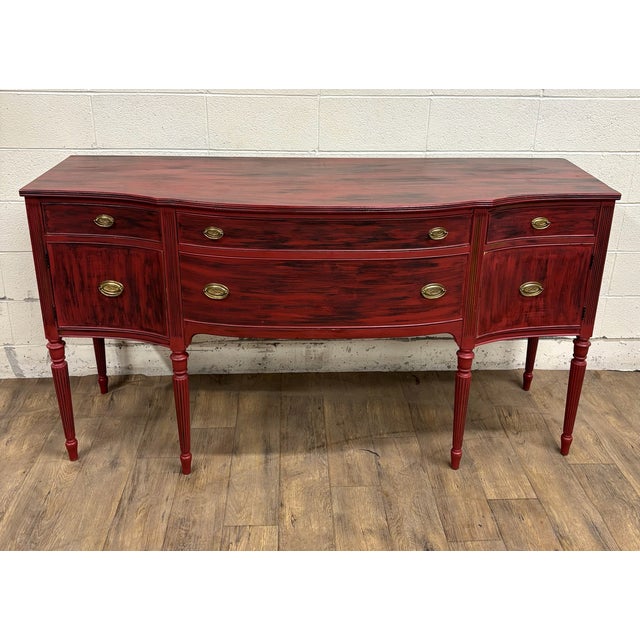 This is an absolutely stunning vintage Federal style Hepplewhite distressed red farmhouse style bow front sideboard,...