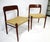 A pair of elegant classic Danish modern teak framed side chairs with sculptural back rails and woven seat bottoms. Sturdy...