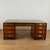 Impressive vintage partners desk crafted in satinwood and mahogany, featuring three tooled leather panels on a brass...
