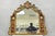 Antique French Neoclassical Baroque Style Gold Gilt Gesso Red Glass Frame Wall Mirror. Item features a figural cameo...