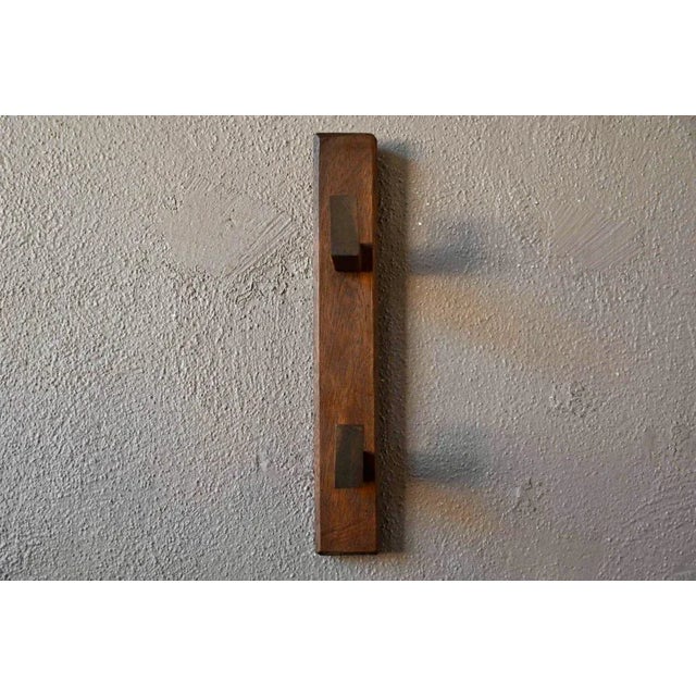 The design of this wall-mounted coat rack, in an assumed raw minimalism, evokes simplicity and country rusticity. Made...