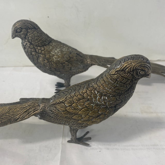 Pair of metal pheasants with long feather detail has a Hollywood Regency or Palm Beach style aesthetic. A rich accent for...