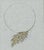 Original jewelry design drawing of an asymmetrical collar necklace with layered gold-tone leaf forms accented by small...