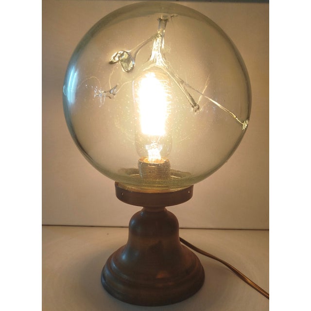 This piece was blown in our workshop; the glass is entirely handmade with a brass base and French electrical assembly. The...