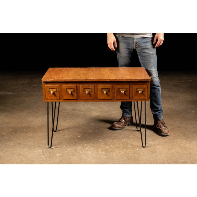 Vintage Danish card catalog featuring six uniformly sized drawers arranged in a single horizontal row. Each wooden drawer...