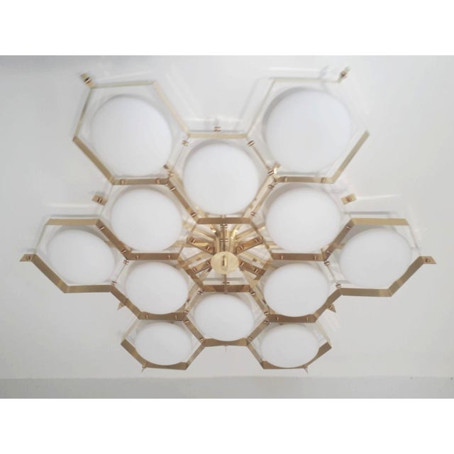 Italian midcentury flush mount with twelve matte white Murano glass shades mounted on solid brass frame in lacquered...