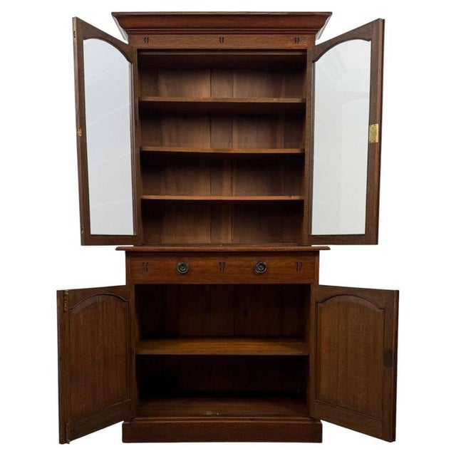 An impressive early 20th-century English bookcase in the Arts and Crafts tradition, finely crafted from oak and combining...