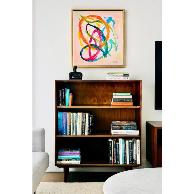 Simple + Classic Mid Century Modern ROSEWOOD bookcase, c. 1960's. This stunning piece features three wide and long...