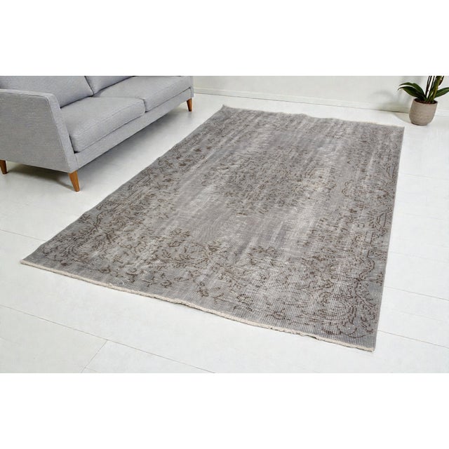 This is a vintage Turkish Oushak rug from the Mid 20th Century . The piece was hand-knotted.