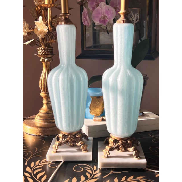 This is a GORGEOUS and pair of midcentury Murano glass lamps with cast metal and marble bases and the most beautiful blue...