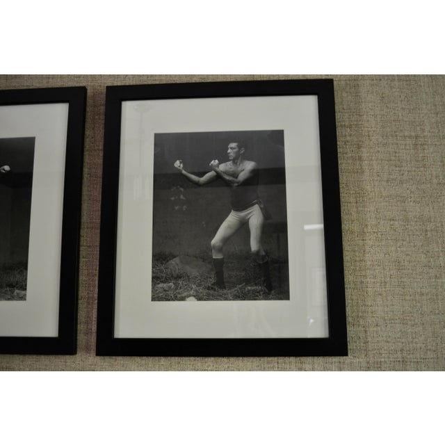 Unique pair of large English photographs of a father and son boxing in a simple black wide gallery frame. 25.25" x 29.25"...