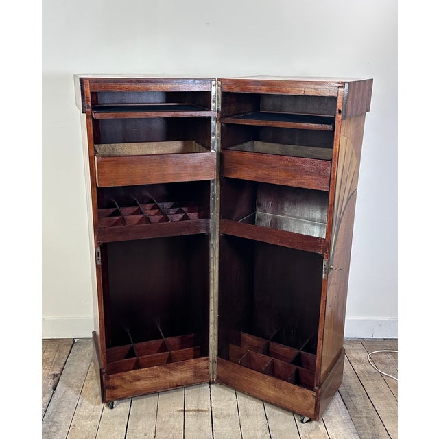 Art Deco period bar in marquetry with palm leaf decoration on the front and two small leaves on the sides, opening to...