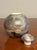 This vintage mid-century modern studio pottery vessel features a compact, rounded form with a fitted lid, emphasizing...