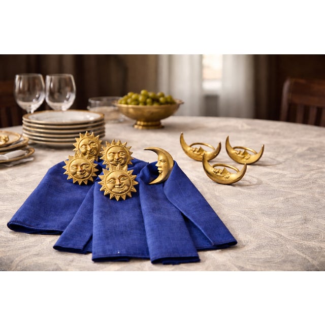 Vintage gold napkin ring set featuring a whimsical celestial motif with alternating sun and crescent moon faces. This set...